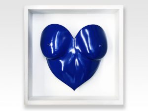 blue painted heart shaped breast cast in a white wooden frame